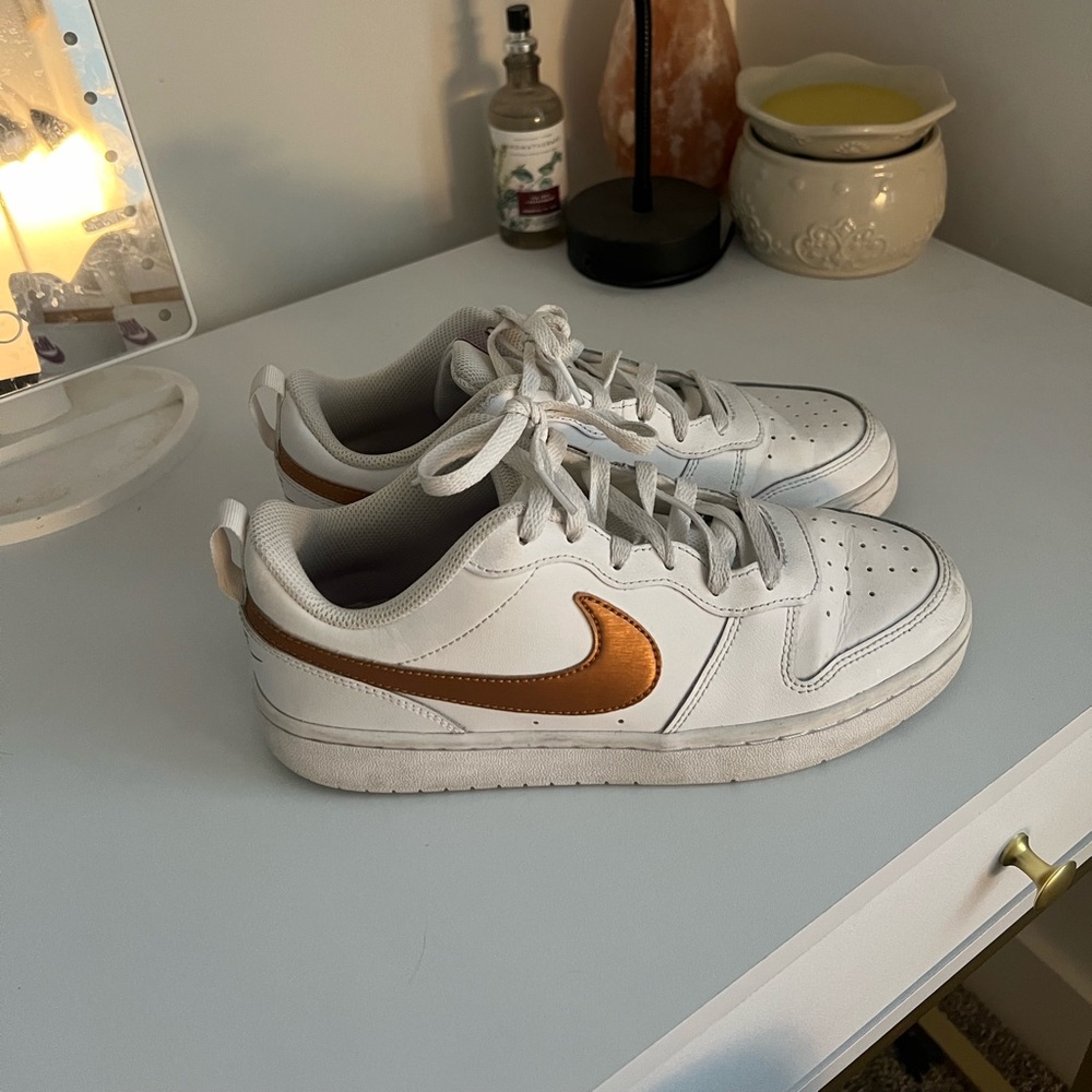 White and gold Nike air forces